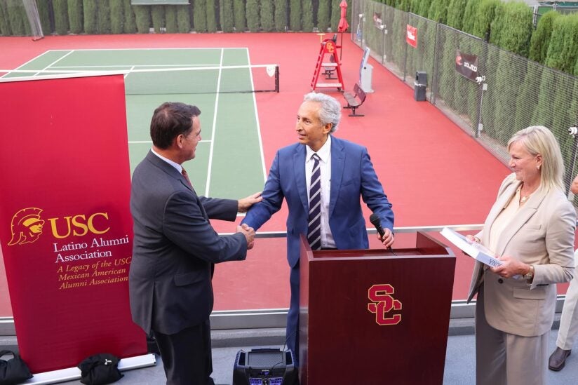 Rafael Belmar Osuna presents book to USC Athletic Director Mike Bohn