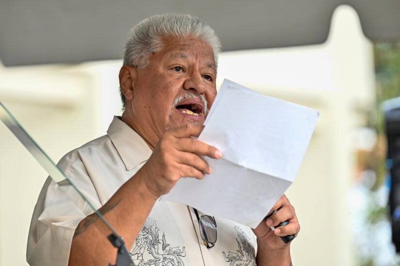 Poet Luis Rodriguez reading a speech.