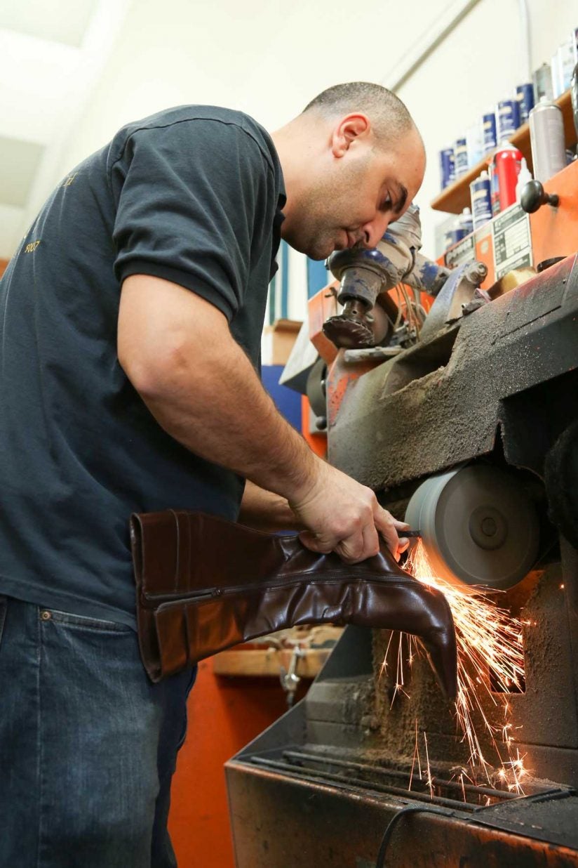 Sean Keklikyan uses machine to work on shoes 