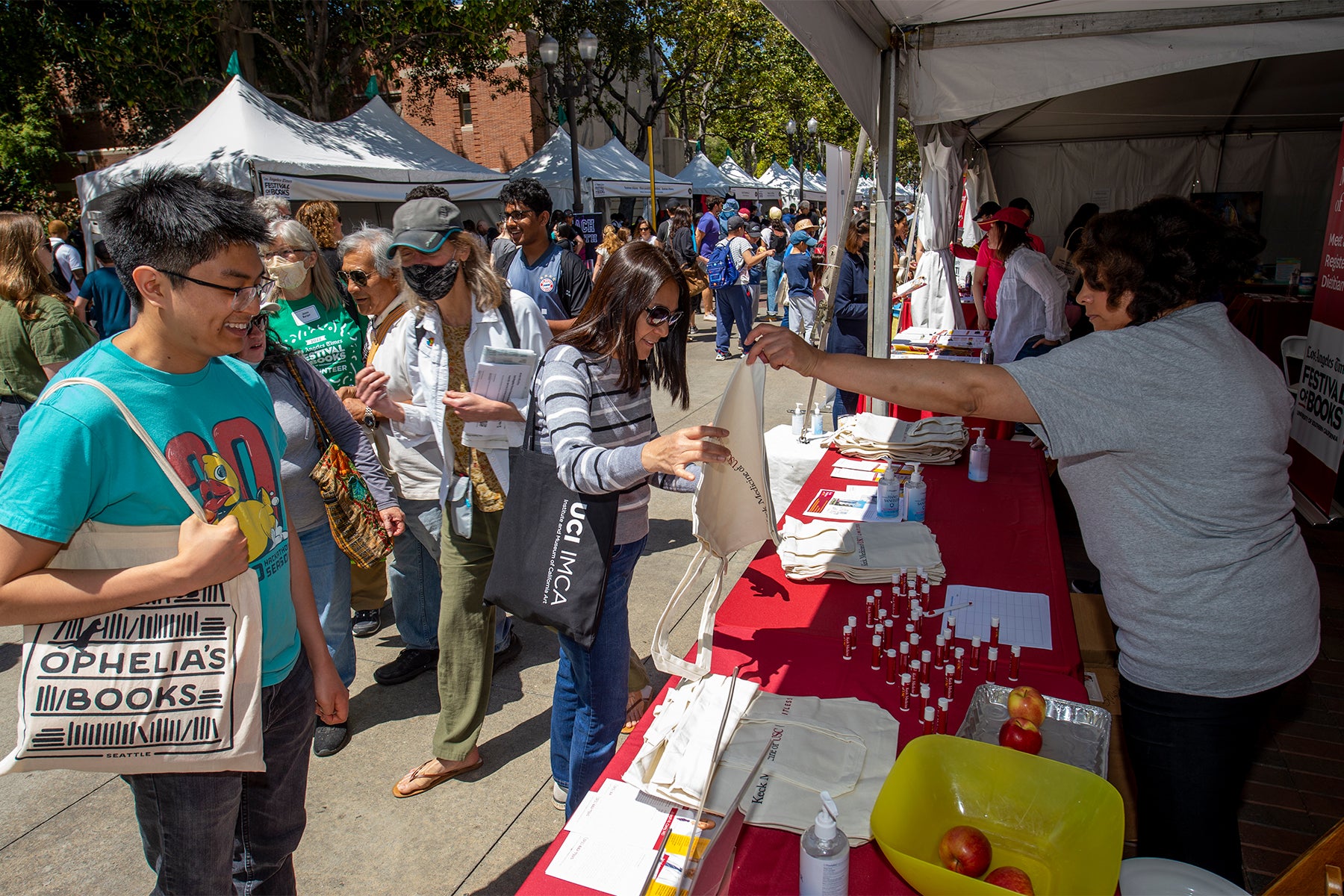 2022 Los Angeles Times Festival of Books at USC: people taking pamphlets