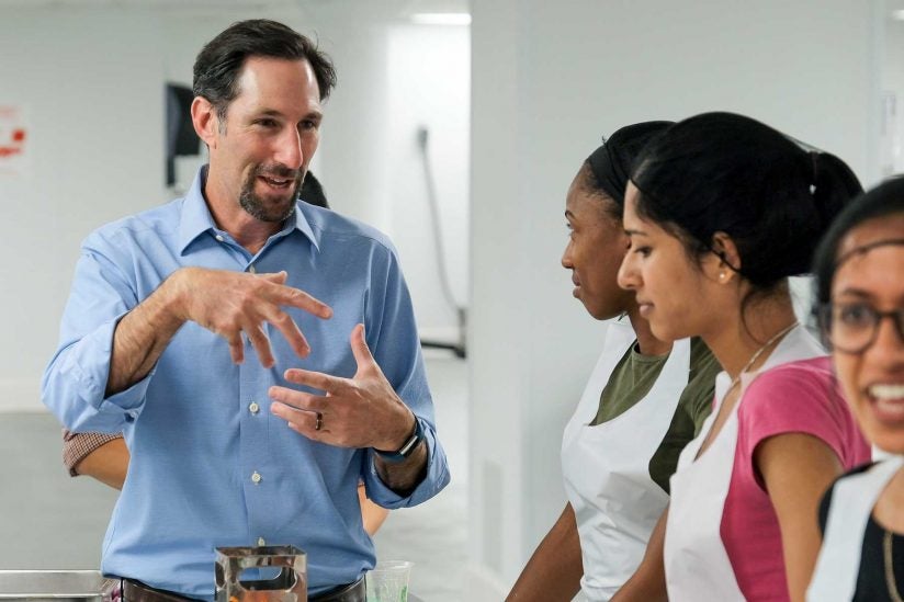 Greg Harlan speaks to students in kitchen