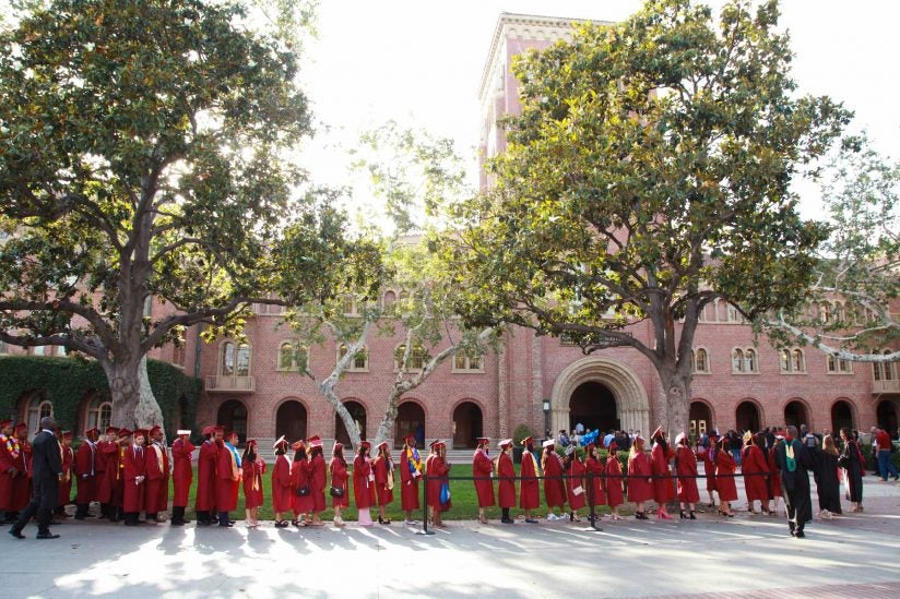Hybrid high graduates line up in front of Bovard for a ceremony