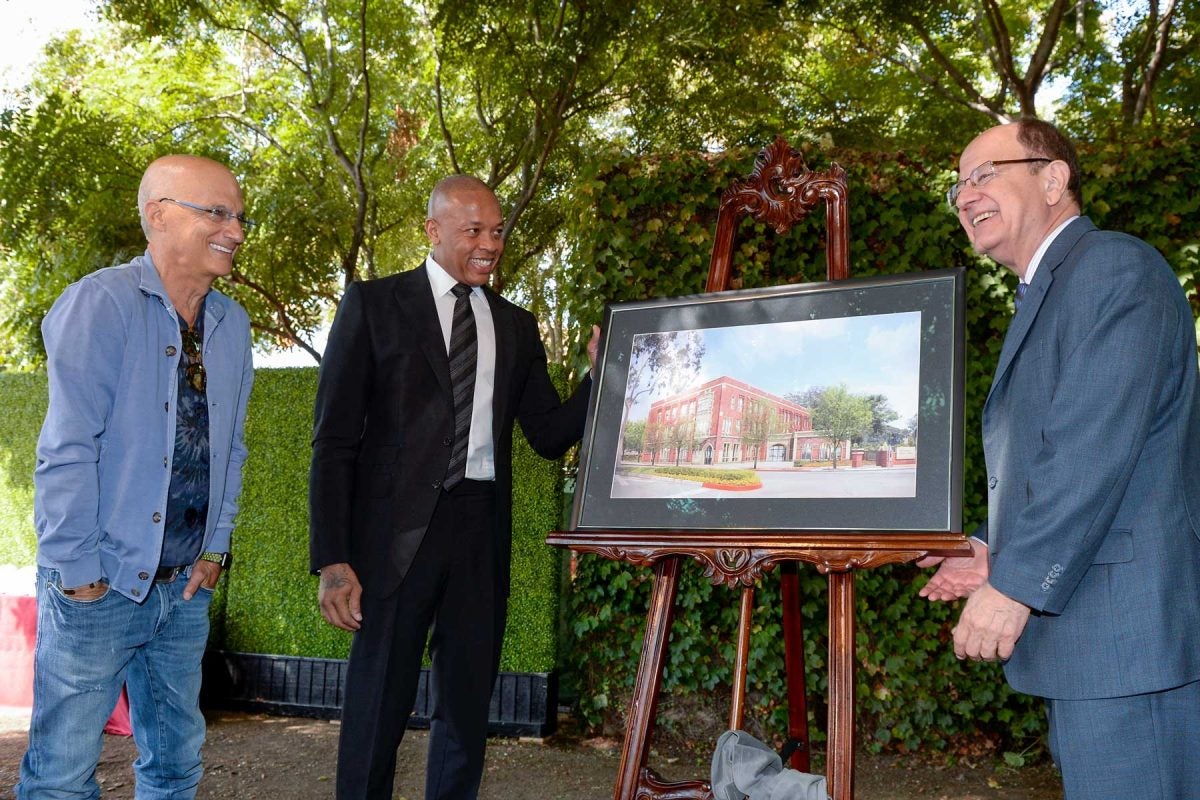 Jimmy Iovine, Andre Young and President and Nikias looking at rendering
