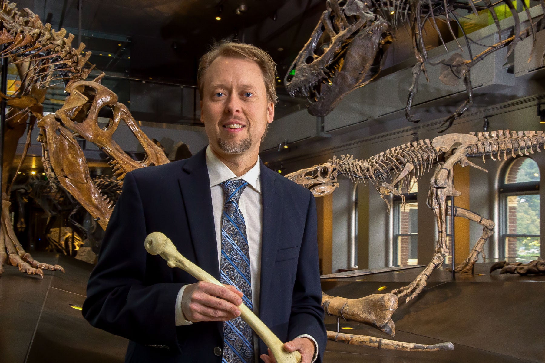 Kristian J. Carlson holds a human femur bone
