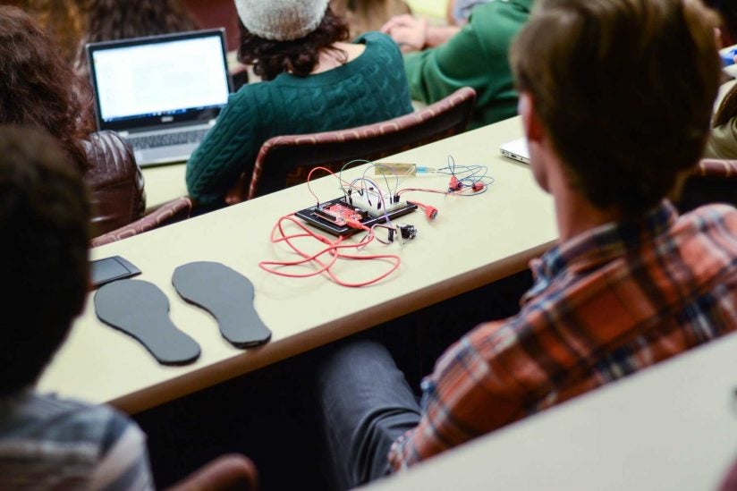 students in audience with project on desk