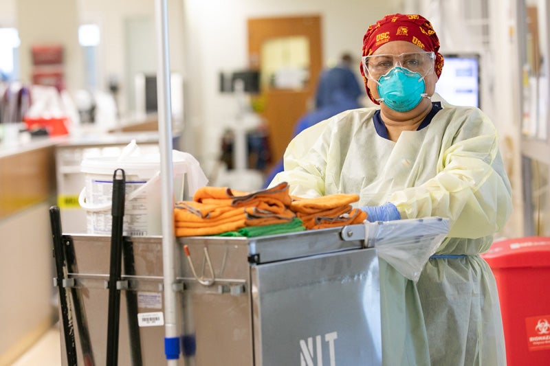 Maria Saravia with cleaning gear and disinfecting supplies at hospital