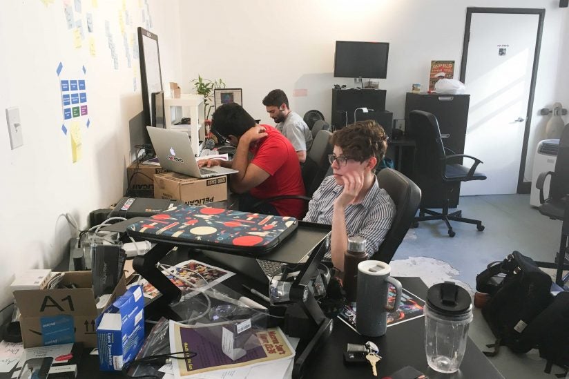 Three employees working at computers at Mira Office