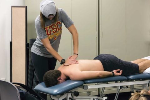 PT students doing spine exam