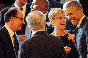 USC President C. L. Max Nikias and Elizabeth Garrett, provost and senior vice president for academic affairs, congratulate President Barack Obama. (Photo/Getty Images)