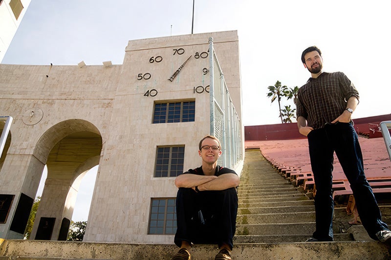 Charles Palmer and Andrew Ezarik in front of the Coliseum's thermometer.
