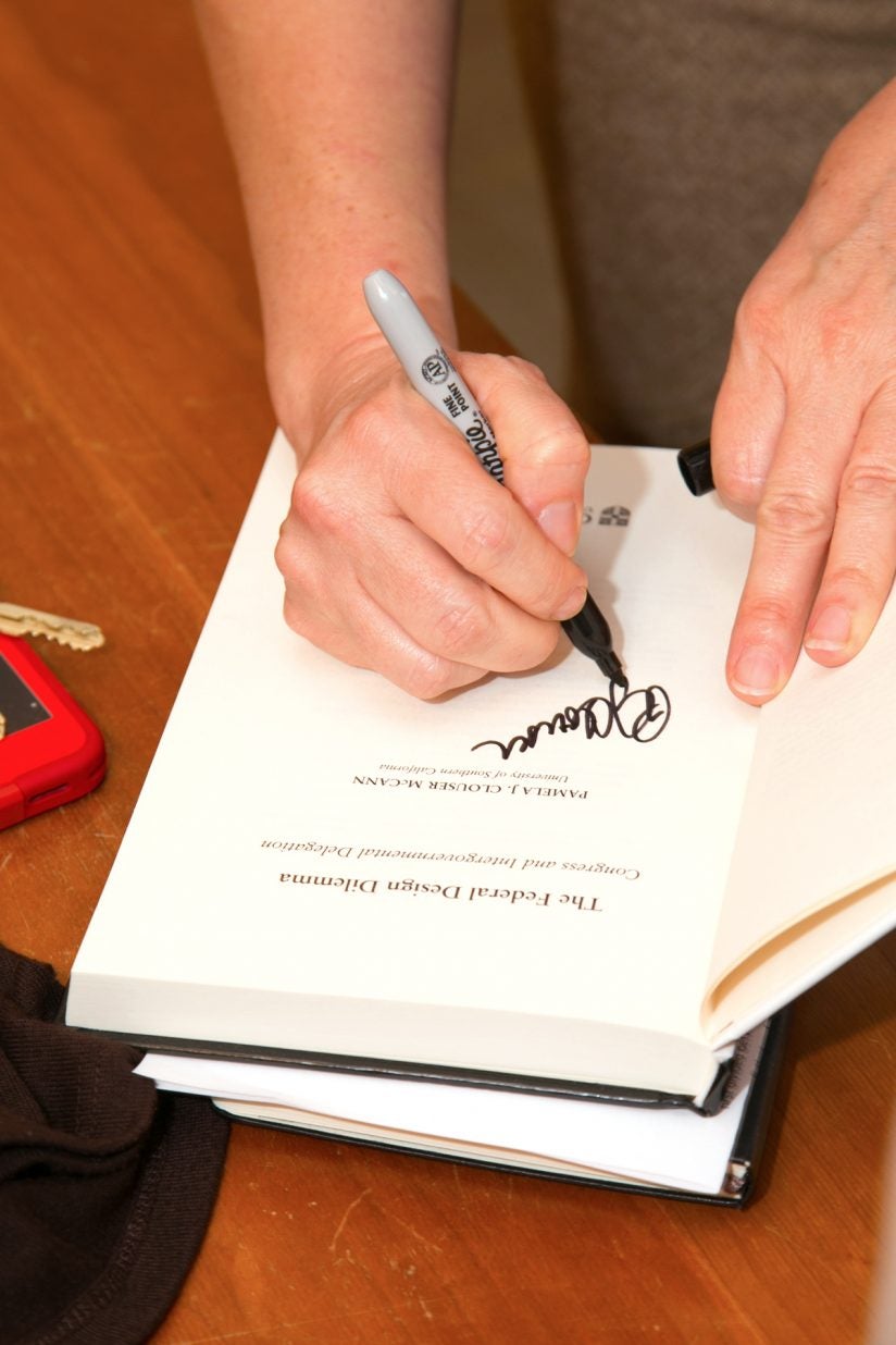 Pamela McCann signs book