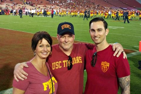 Jeremy Fricke with his parents at a USC football game