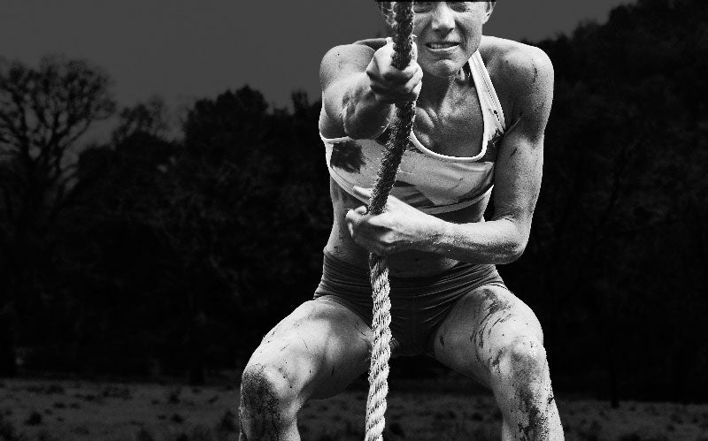 Athletic woman pulling rope