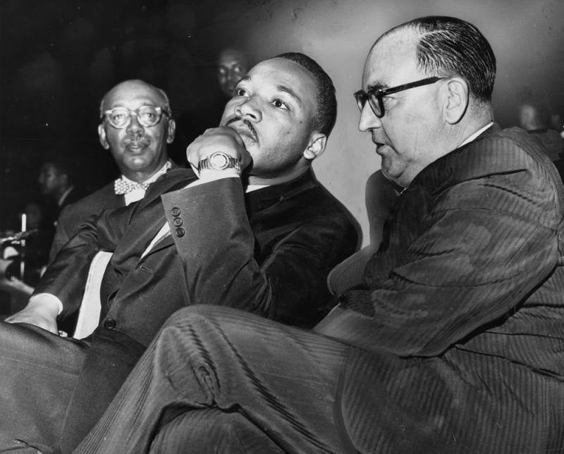 Martin Luther King Jr. sits next to California Gov. Edmund Brown at a freedom rally at the Los Angeles Sports Arena.