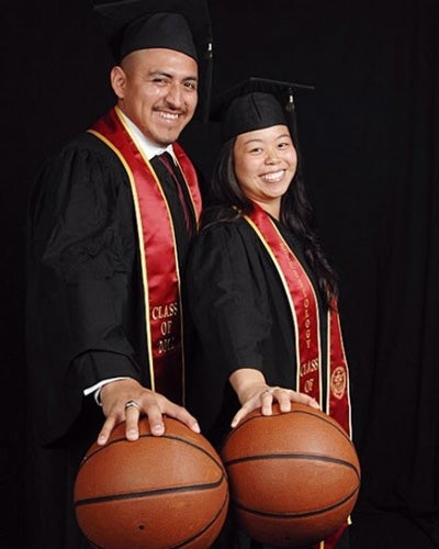 Dahliena and Bryan Chavac in USC graduation caps, gowns and sashes, each palming a basketball.