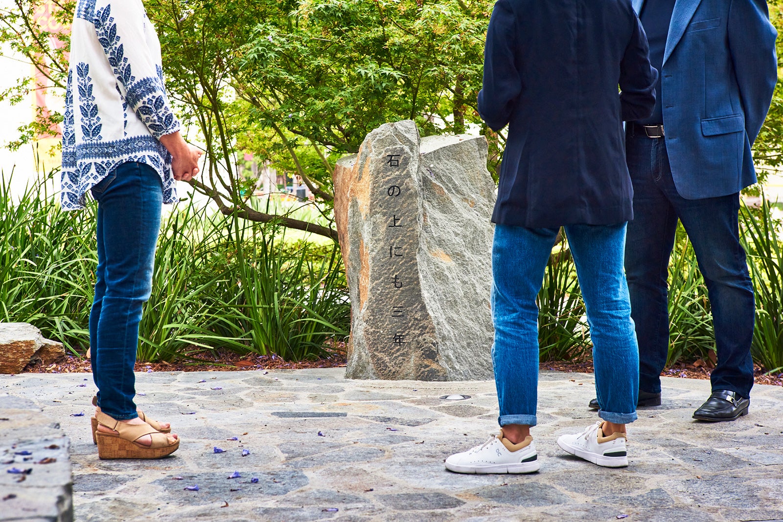 Japanese American family of USC alumni view a rock garden on campus