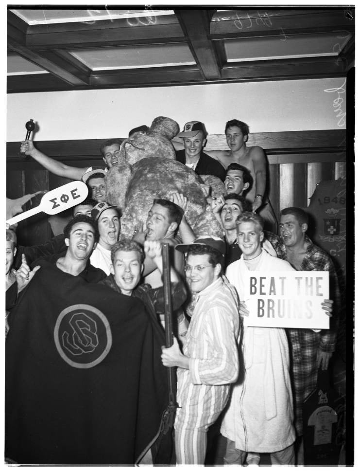 USC students pose with stuffed bear stolen from Bruin Theatre.