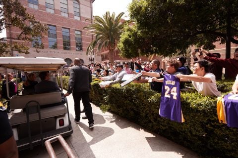 Kobe Bryant walks past fans at USC