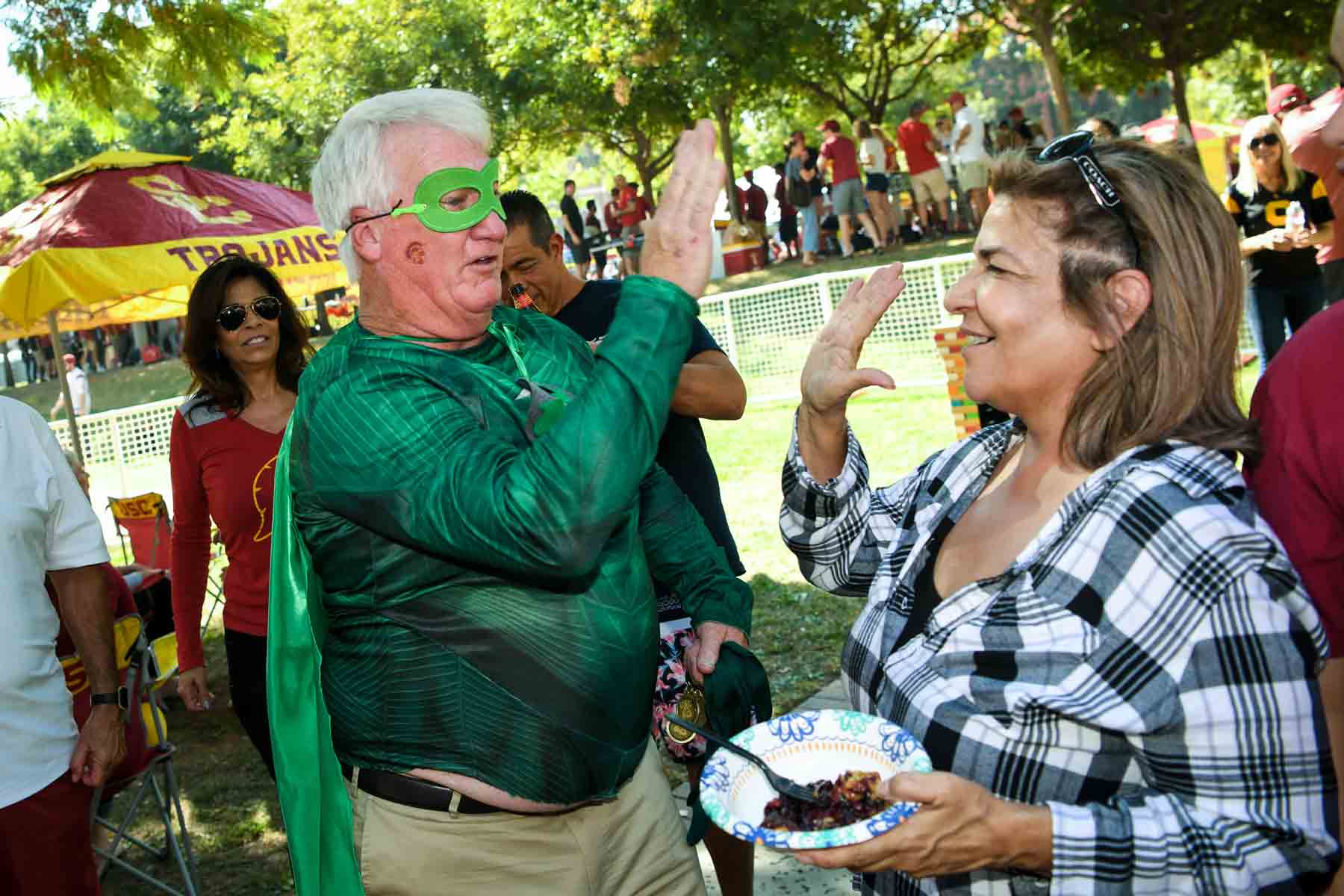 Recycle Man high-fiving a USC tailgater