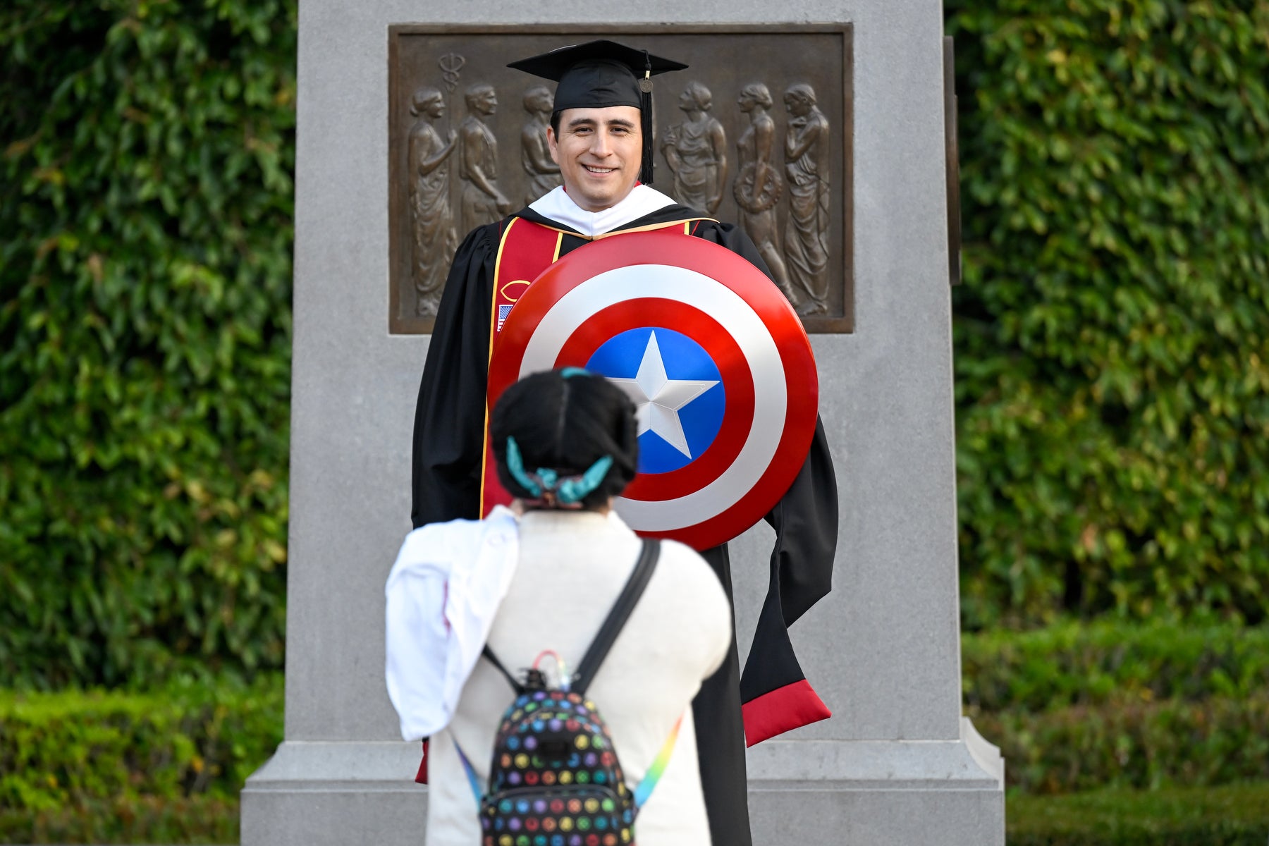 USC 2023 commencement: Graduate Charles Hughes with Captain America shield