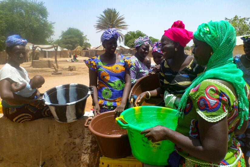 Gambia women socializing while collecting water.