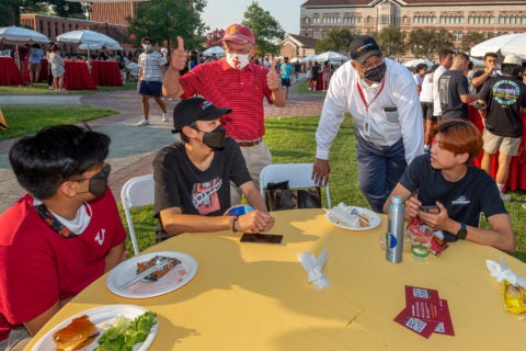 Charles Zukoski and WInston Crisp visit with students during welcome dinner