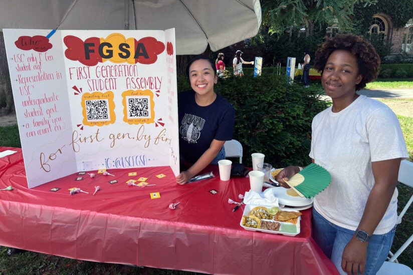USC’s Student Equity and Inclusion Programs: Celine De Villa and Farrah Diogene staff booth