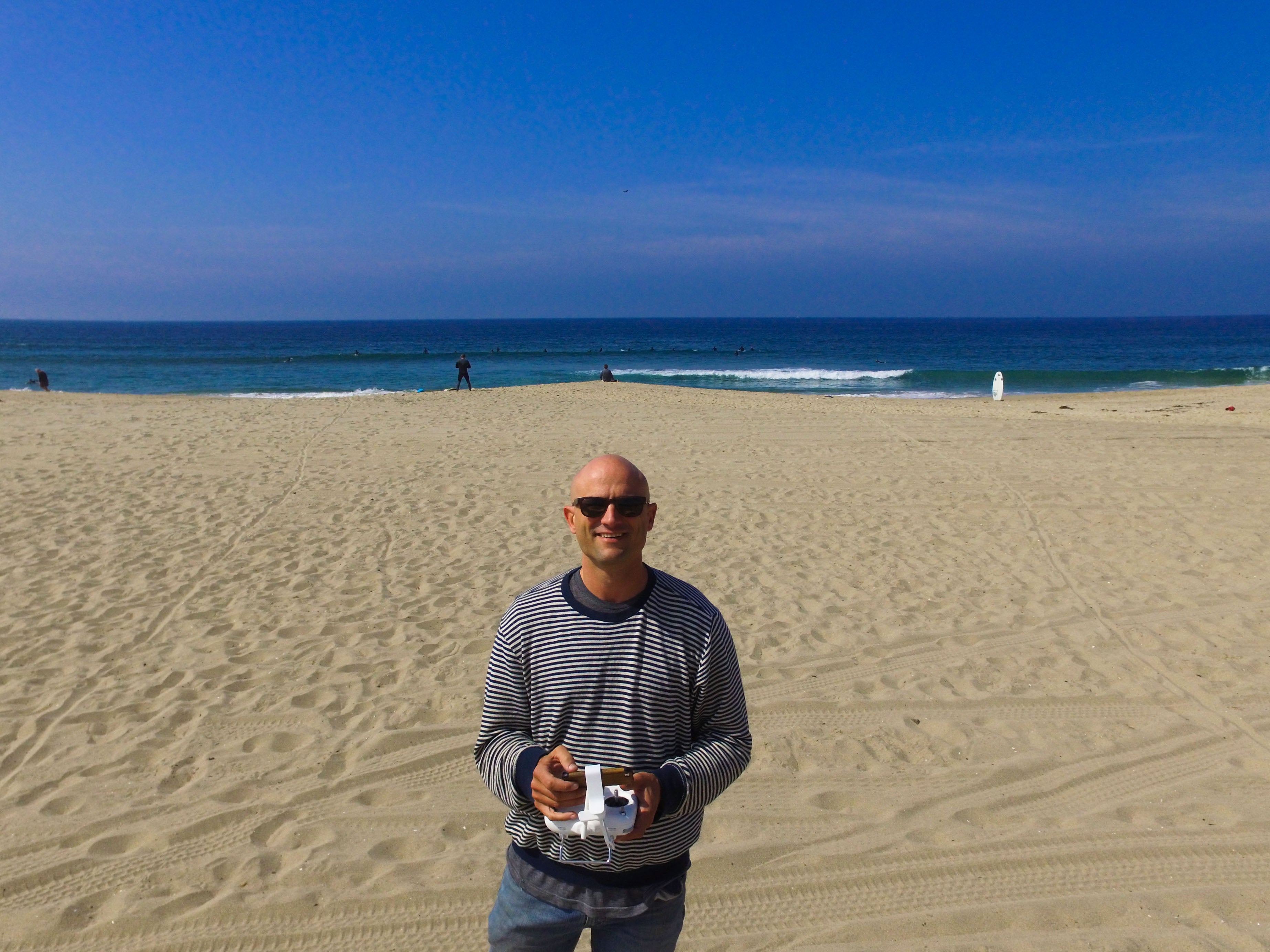 Portrait of Keith Plocek at the beach flying a drone