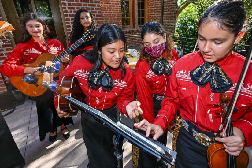 USC mariachi: Members look over their music