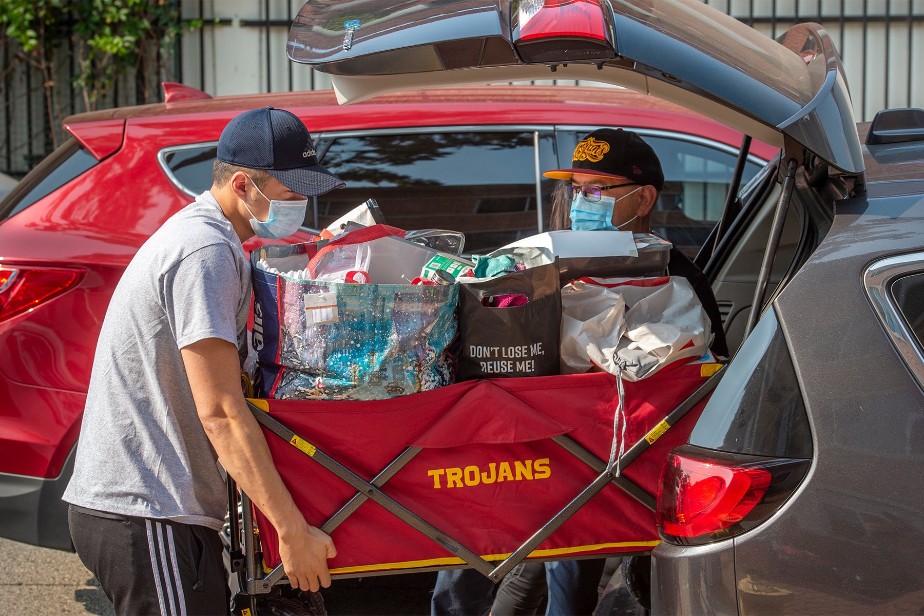 Robert Colberg and Eric Esguerra unload a wagon