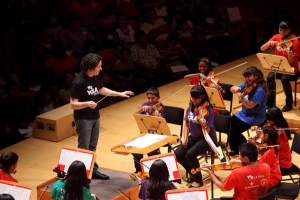 PHOTO by Mathew Imaging: LA Philharmonic conductor Gustavo Dudamel leads children in the Youth Orchestra of Los Angeles.