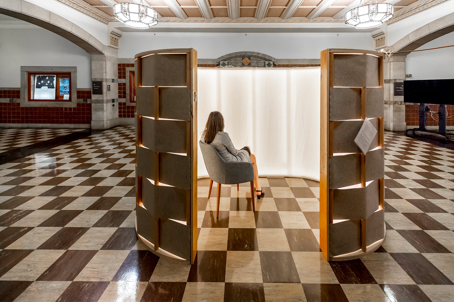 A person inside a round structure meant to provide a solitary space for healing.