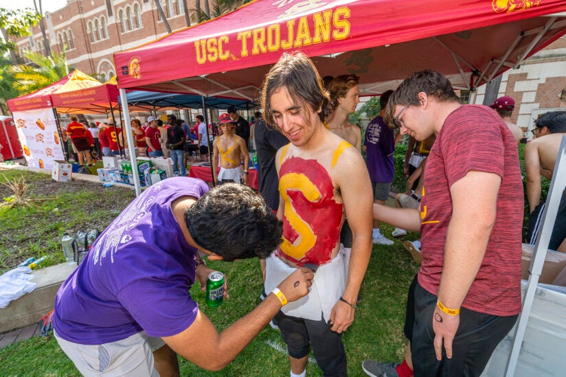 USC Reunion Weekend 2021: USC students Soham Saxena and Adam Botnen paint an "S" on Hudi Potash