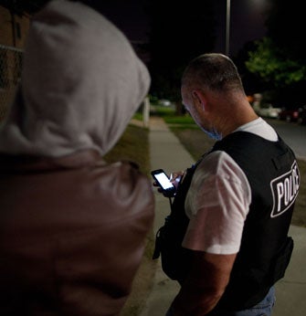 a police officer using a mobile device