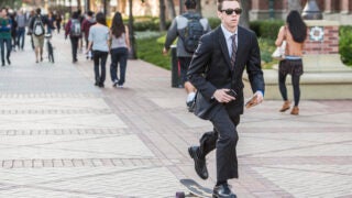 student skates down Trousdale