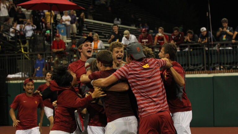 Men's tennis team celebrate win against Oklahoma
