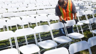 Worker assembling chairs ahead of commencement ceremony