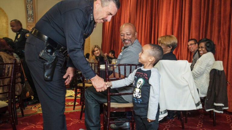 police officer shaking hands with child