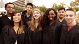 Various graduates coming together for a photo