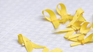 Yellow ribbons strewn about on a table