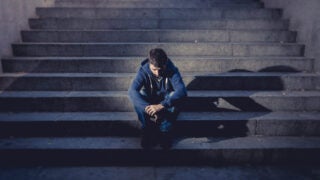 male sitting on staircase