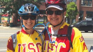 C. L. Max Nikias and Niki C. Nikias wearing USC biking attire