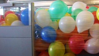 cubicle filled with balloons