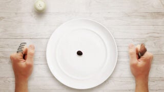empty plate with singular olive