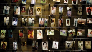 Various pictures of hanging on strings against a wall