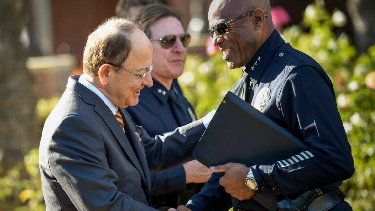 Former USC President Max Nikias greeting Earl Paysinger