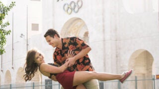 Alumni Ada Del Rosso and Corbin Johnson in front of the L.A. Coliseum