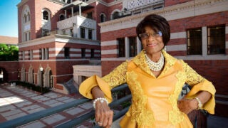 Verna Dauterive standing in front of Dauterive Hall