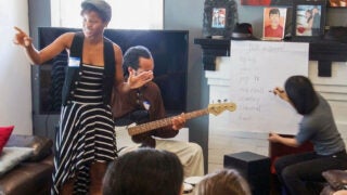 Teacher helping students with autism learn music