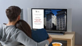 Two people watching television on the couch